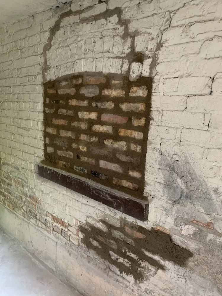 Close-up of finished tuckpointing work showing fresh mortar on exposed brick
